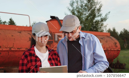 two farmer tablet farming, conversation field team, group transaction teamwork, farming business, farm machine tractor, harvesting machinery, handclasp forever loan greeting, agreement friendship road 107856647