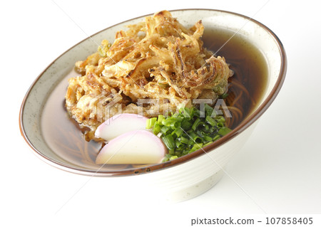 Kakiage soba with fish cake, green onions, and tempura soba photographed against a white background Kakiage soba with fish cake, green onions, and tempura soba photographed against a white background 107858405