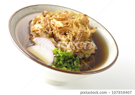Kakiage soba with fish cake, green onions, and tempura soba photographed against a white background Kakiage soba with fish cake, green onions, and tempura soba photographed against a white background 107858407