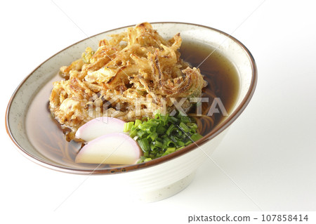 Kakiage soba with fish cake, green onions, and tempura soba photographed against a white background Kakiage soba with fish cake, green onions, and tempura soba photographed against a white background 107858414