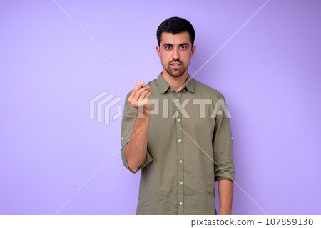 Young deaf mute man asking money using sign language on blue background Young deaf mute man asking money using sign language on blue background 107859130