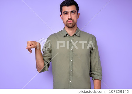serious handsome man showing letter X x with fingers serious handsome man showing letter X x with fingers 107859145