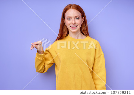 letter T spelling by girl's hand in American Sign Language ASL on blue background 107859211