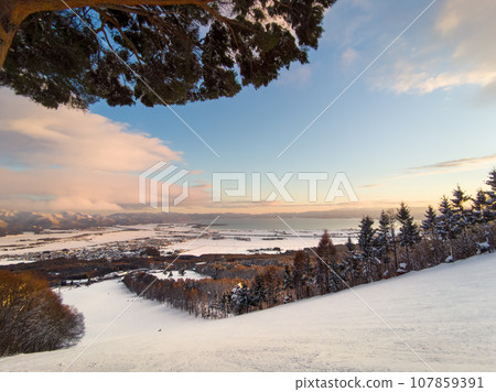 Ski resort in the evening with a view of a large lake in the distance (Fukushima Prefecture, Inawashiro) Ski resort in the evening with a view of a large lake in the distance (Fukushima Prefecture, Inawashiro) 107859391