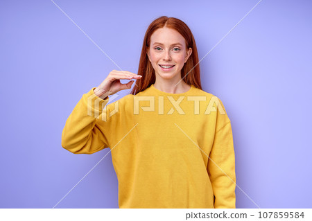 letter D spelling by girl's hand in American Sign Language ASL on blue background letter D spelling by girl's hand in American Sign Language ASL on blue background 107859584