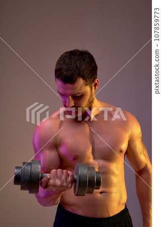 young motivated bodybuilder works out at studio young motivated bodybuilder works out at studio 107859773