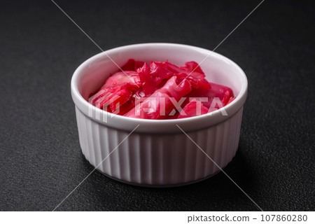 Delicious spicy pink cabbage sliced and cooked in Korean style on a ceramic plate Delicious spicy pink cabbage sliced and cooked in Korean style on a ceramic plate 107860280