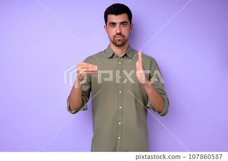 Young serious bearded deaf mute man showing number 500 Young serious bearded deaf mute man showing number 500 107860587
