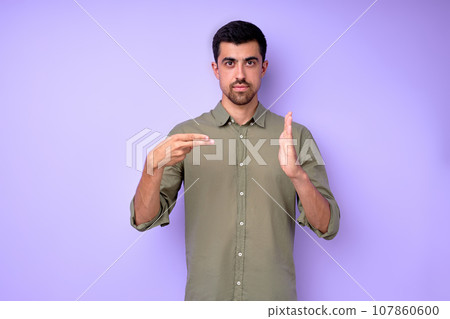 Young serious bearded deaf mute man showing number 200 Young serious bearded deaf mute man showing number 200 107860600