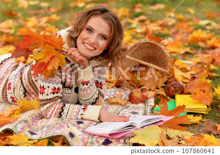 Portrait of young woman resting in park 107860641