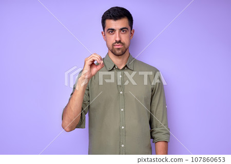 serious handsome man showing letter O o with fingers serious handsome man showing letter O o with fingers 107860653