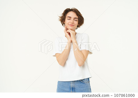 Portrait of carefree girl, gentle and feminine woman with short hair, laughing, posing over white studio background Portrait of carefree girl, gentle and feminine woman with short hair, laughing, posing over white studio background 107861000