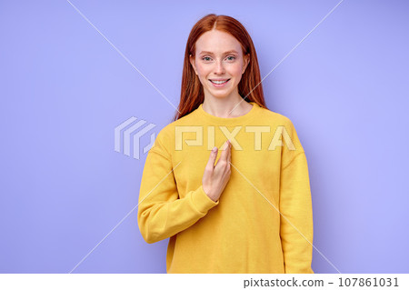 smiling ginger girl pointing to herself smiling ginger girl pointing to herself 107861031