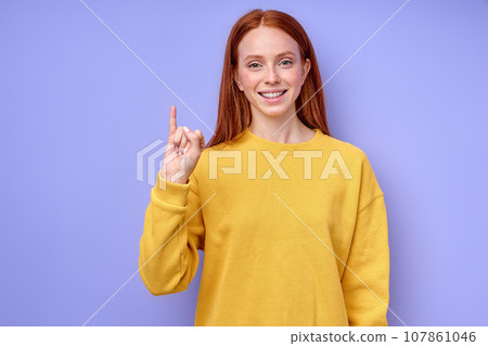 beautiful redhead happy cheerful girl, teacher showing letter J beautiful redhead happy cheerful girl, teacher showing letter J 107861046