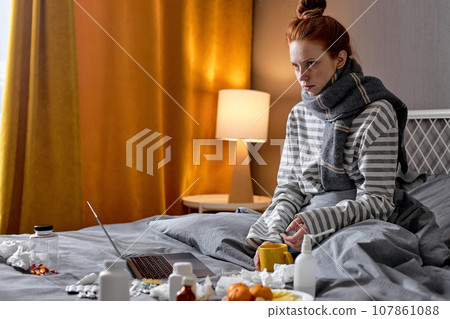 angry frustrated unhappy girl sitting on bed angry frustrated unhappy girl sitting on bed 107861088