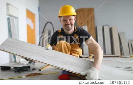 Qualified carpenter man carry wooden plank on working project, energetic worker Qualified carpenter man carry wooden plank on working project, energetic worker 107861123