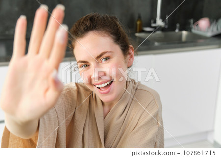 Attractive young cheerful girl baking at the kitchen, making dough, holding recipe book, having ideas Attractive young cheerful girl baking at the kitchen, making dough, holding recipe book, having ideas 107861715