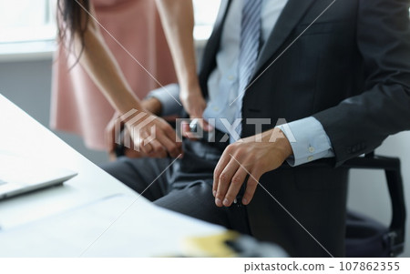 Secretary unzip boss belt at working place, harassment or work affair Secretary unzip boss belt at working place, harassment or work affair 107862355