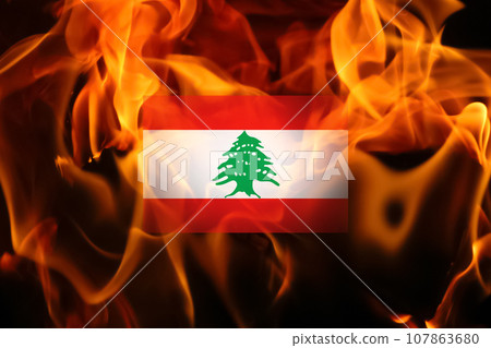 Flag of Lebanon on the flame fire background. War or protests in Lebanon, Beirut 107863680
