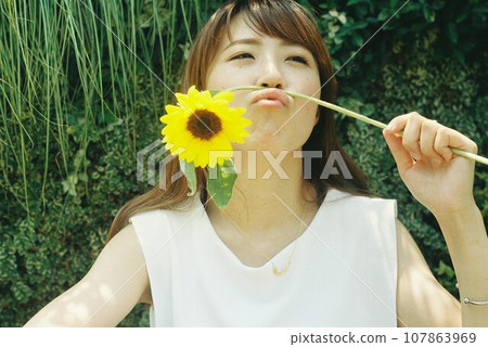 Summer woman portrait with sunflowers 107863969