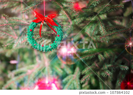 Christmas background with a beautiful Christmas toy and light beams from a garland. 107864102
