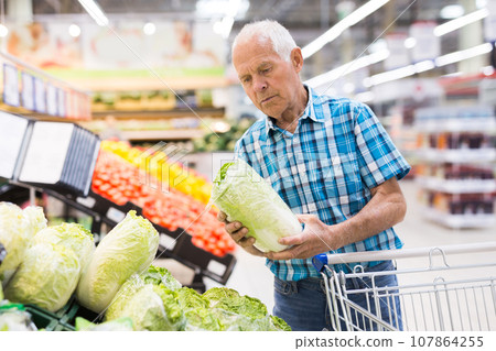 Old age man choosing pekinensis cabbage in supermarket Old age man choosing pekinensis cabbage in supermarket 107864255