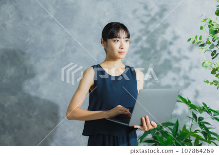 A woman using a computer 107864269
