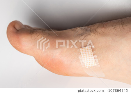 Sticky plaster on human foot Sticky plaster on human foot 107864545