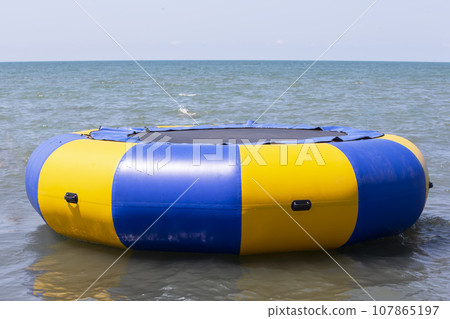 Sea trampoline in the form of a life buoy. Trampoline on the sea. 107865197