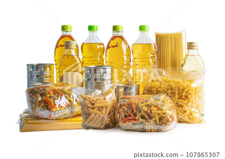 Foodstuff for donation, storage and delivery. Various food, pasta, cooking oil and canned food in cardboard box. Foodstuff for donation, storage and delivery. Various food, pasta, cooking oil and canned food in cardboard box. 107865307