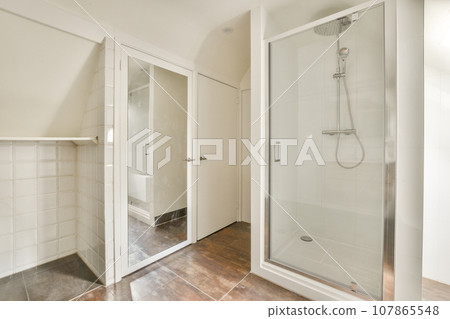 a bathroom with a glass shower door and tiled floor in the corner, next to a walk - in shower stall a bathroom with a glass shower door and tiled floor in the corner, next to a walk - in shower stall 107865548