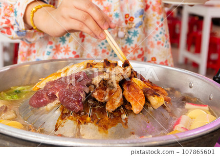 Close up of pook bbq Thai food style. shabu sukiyaki or Moo-Ka-Ta griiled pork. Close up of pook bbq Thai food style. shabu sukiyaki or Moo-Ka-Ta griiled pork. 107865601