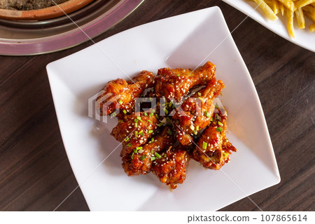 Korean BBQ chicken. The classic Korean dish. Street food on Korean. Korean BBQ chicken. The classic Korean dish. Street food on Korean. 107865614