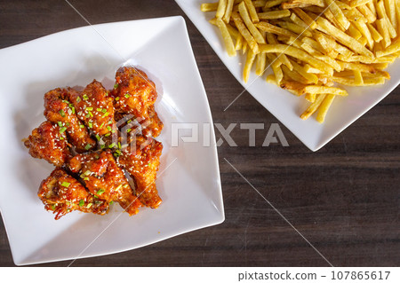 Korean BBQ chicken and french fries. The classic Korean dish. Street food on Korean. 107865617