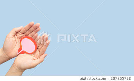 Hand holding bladder and prostate gland made from paper on blue background. Awareness of BPH, prostate cancer, bladder cancer and men health care. Urology and male reproductive concept. Copy space. Hand holding bladder and prostate gland made from paper on blue background. Awareness of BPH, prostate cancer, bladder cancer and men health care. Urology and male reproductive concept. Copy space. 107865758