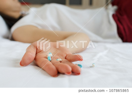 Close up of woman hand with many pills. Drug addiction and social issue for teenager. Take an overdose concept Close up of woman hand with many pills. Drug addiction and social issue for teenager. Take an overdose concept 107865865