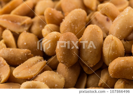 large amount of peeled salted peanuts 107866496