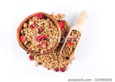 Muesli oat cereals close up background with dry fruits Muesli oat cereals close up background with dry fruits 107866500