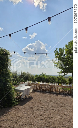 large banquet table in the courtyard of the large beautiful country house  107867270