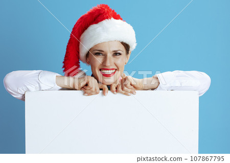 happy female flight attendant on blue showing blank board happy female flight attendant on blue showing blank board 107867795