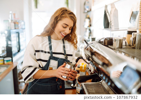 Female barista making coffee in a coffee machine. Conception of business and service. Takeaway food. 107867932