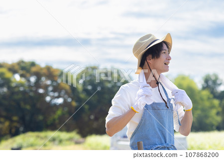 young man working in the field young man working in the field 107868200
