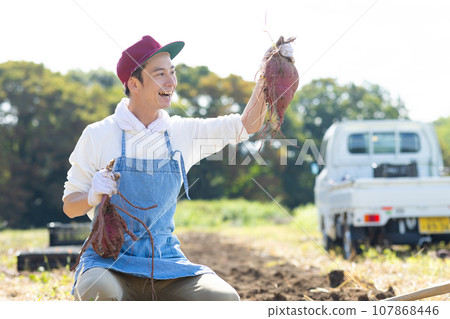 young man plowing the field 107868446