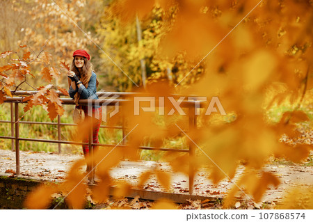 Full length portrait of elegant woman in jeans shirt and hat 107868574