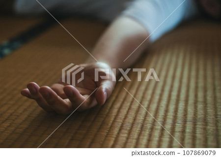 A man sleeping in a Japanese-style room A man sleeping in a Japanese-style room 107869079