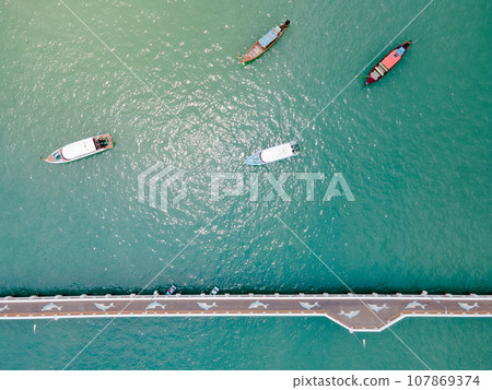 Aerial view of dolphin bridge with boats anchored at Chalong Pier Aerial view of dolphin bridge with boats anchored at Chalong Pier 107869374