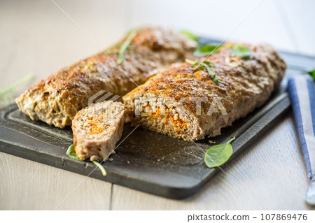 Cooked minced meatloaf with vegetable filling inside. Cooked minced meatloaf with vegetable filling inside. 107869476