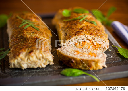 Cooked minced meatloaf with vegetable filling inside. Cooked minced meatloaf with vegetable filling inside. 107869478
