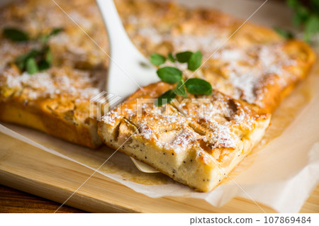 prepared curd semolina pie with quince inside and covered with powdered sugar . prepared curd semolina pie with quince inside and covered with powdered sugar . 107869484