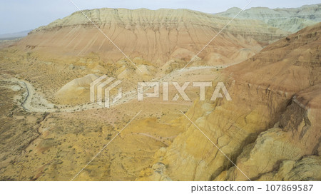 Colorful high mountains and a canyon made of clay Colorful high mountains and a canyon made of clay 107869587